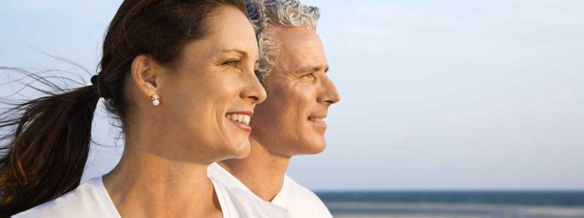 happy active couple at beach