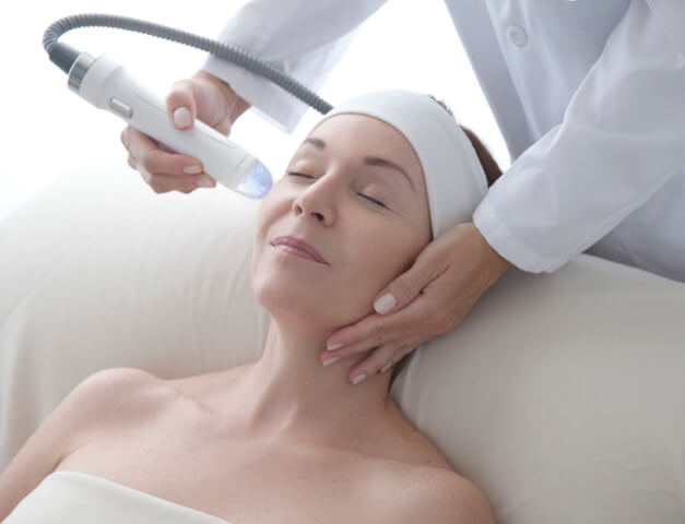 woman receiving microneedling treatment